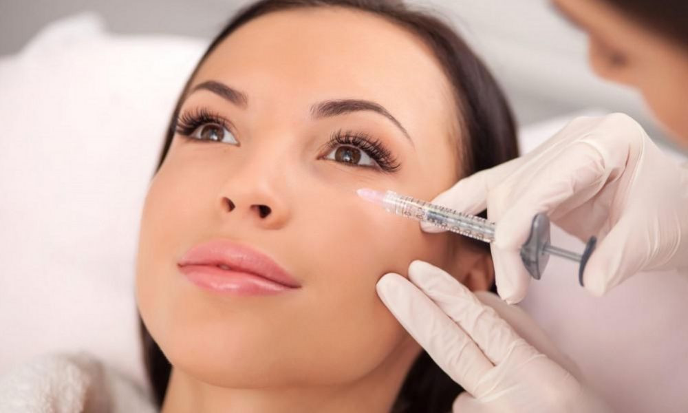 Asian female receives dysport filler in cheek bone by a dermatologist
