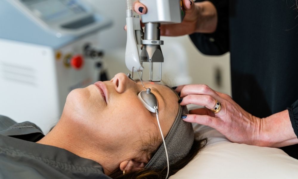 Nurse at Dilworth Dermatology uses a fractional laser on a patient