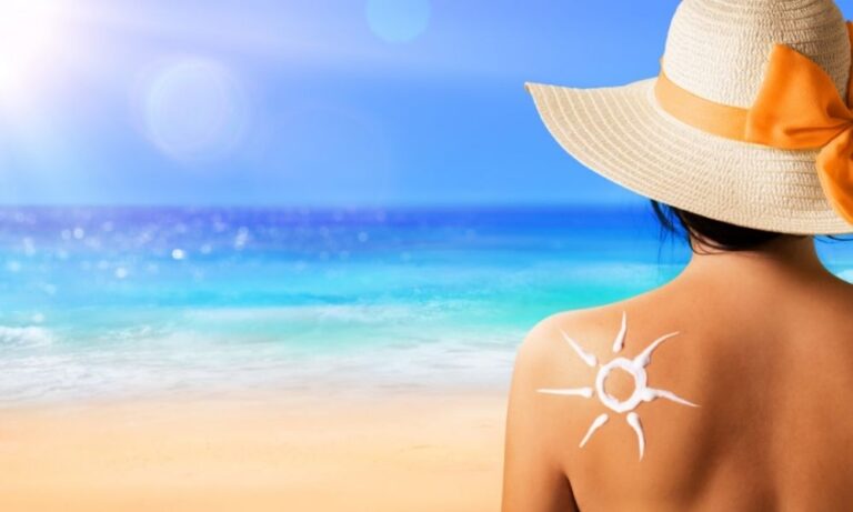 Sun Safety Tips Caucasian Female at beach with sunscreen